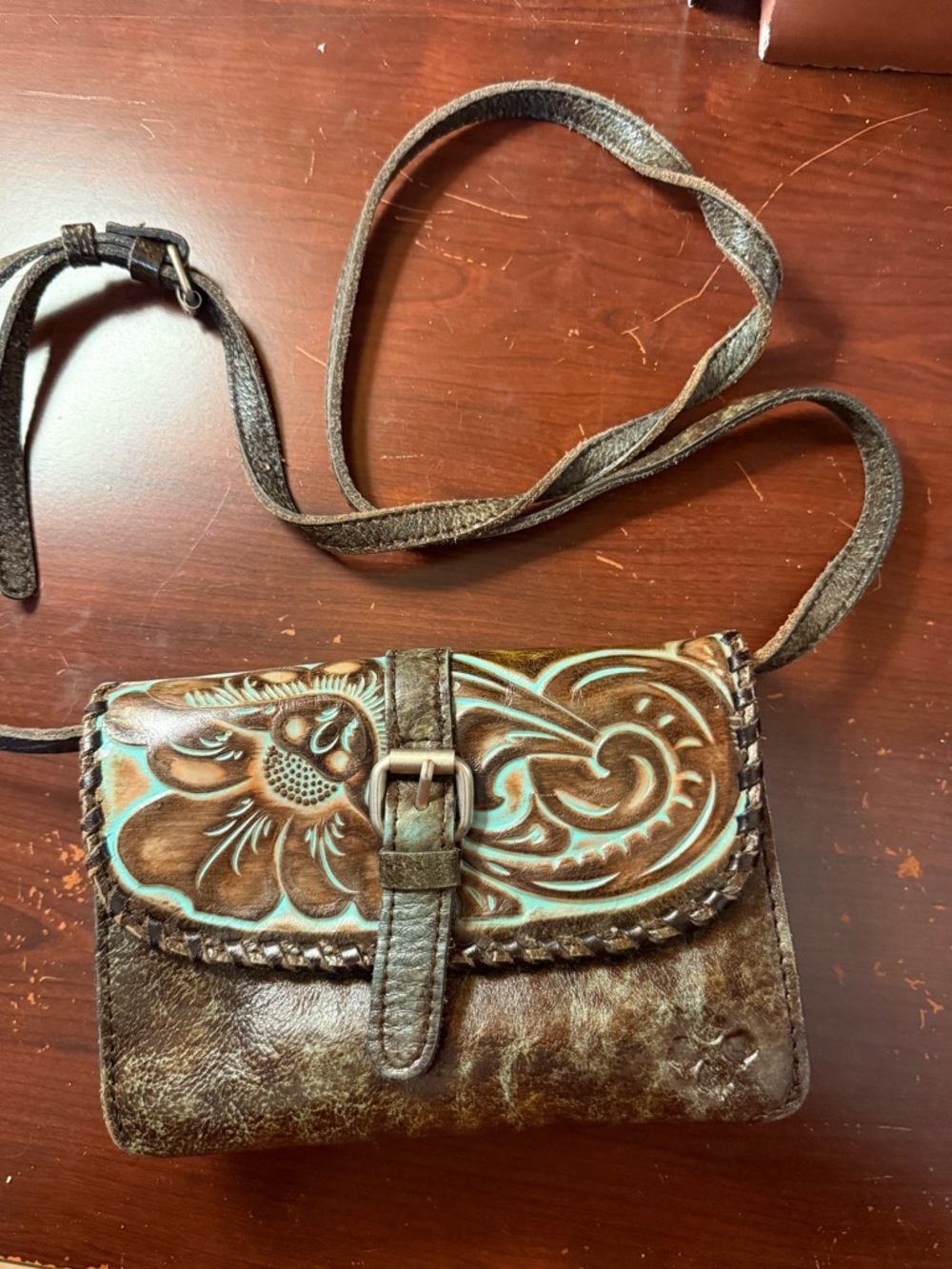 Patricia Nash Torri crossbody bag featuring tooled turquoise leather
